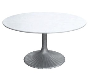 Round table with white stone top and cast aluminum fluted base from Maison Luxe
