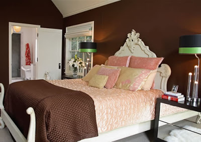 Master bedroom with white carved wood bed, pink and brown bedding and chocolate walls