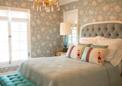 Guest bedroom with Robin's Egg Blue Chrysanthemum wallpaper, light blue tufted headboard, blue bedding and a tufted bench
