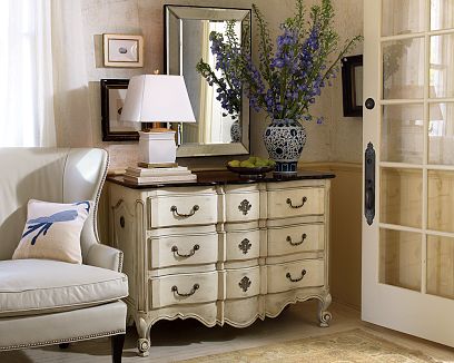 Cream colored serpentine dresser inspired by a Louis XIV bureau from William Sonoma Home