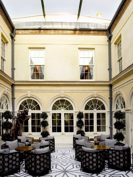 Courtyard at the Lime Wood Hotel with Regency style architecture and a mosaic floor
