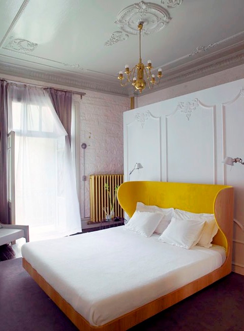 Traditional bedroom with yellow wing back headboard