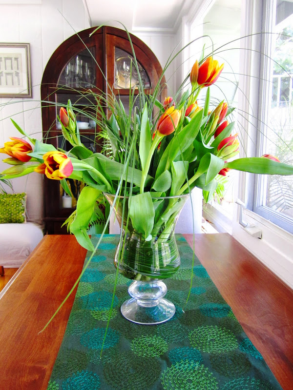 Flower arrangement with orange tulips and wild grass