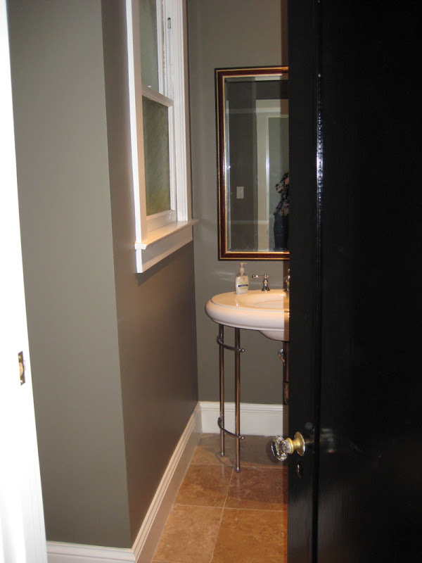 Powder room with grey taupe walls and tile floor