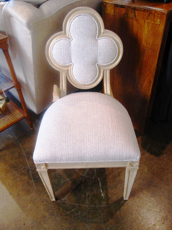 Small side chair with quatrefoil back, cream linen upholstery and an antique white finish from Mecox Gardens