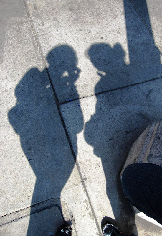 Photo of silhouettes on a side walk