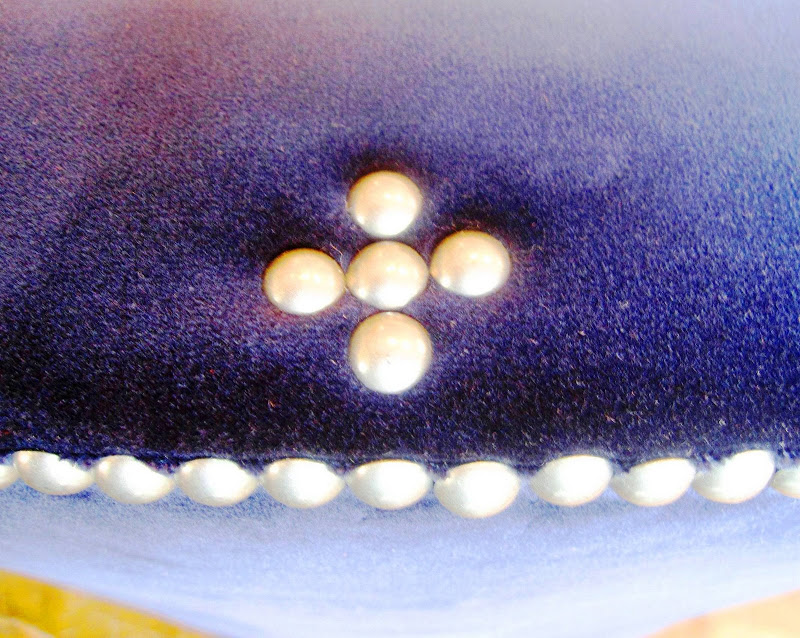 Close up of pweter nail head trim on a blue velvet armchair from Mecox Gardens