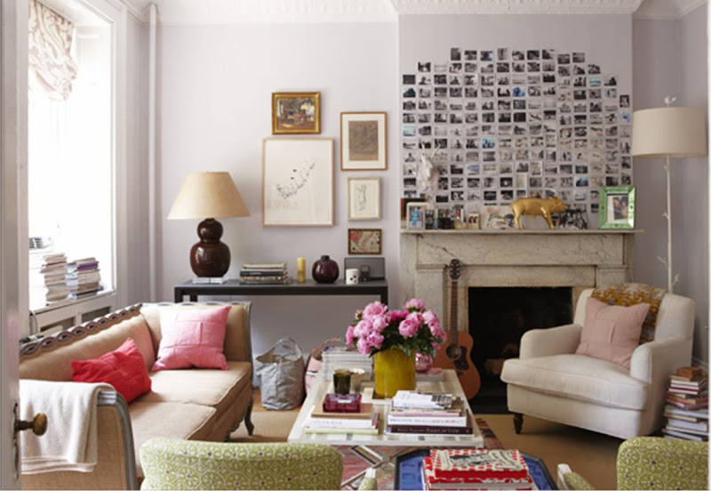 Cozy living room with bright walls, upholstered armchairs and sofa, montage of photos over the fireplace mantel and a gold Harry Allen Bank in the Form of a Pig