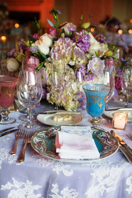 Wedding table setting with lavender hydrangea centerpiece, lace overlay table cloth and French inspired glassware by Delaney Todd Bagwell