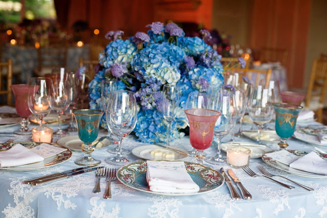 Wedding table setting with lavender hydrangea centerpiece, lace overlay table cloth and French inspired glassware by Delaney Todd Bagwell