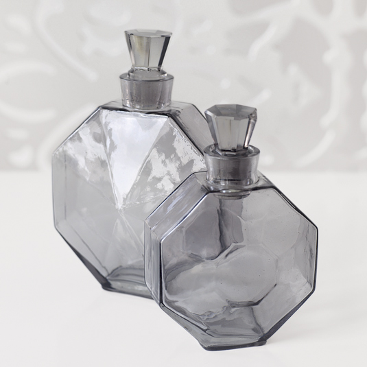 Two grey glass decorative bottles with stoppers from Brocade Home