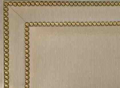Close up of gold nailhead double border trim on an upholstered bed from Jayson Home & Garden