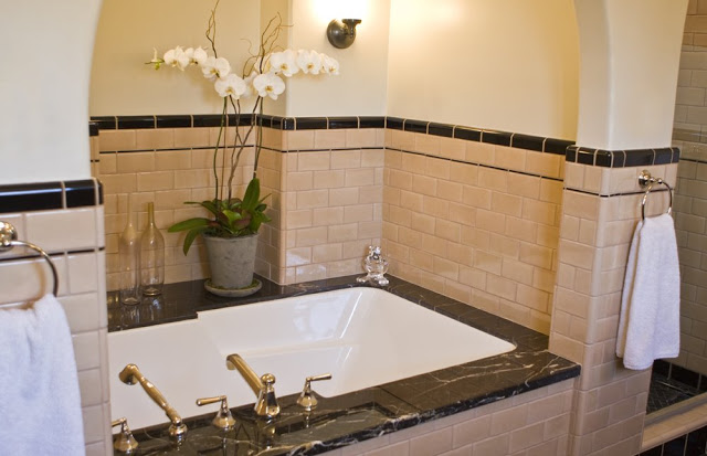 Master bathroom in a Hancock Park home after remodeling with a drop in tub with a marble top, custom vanity and subway tiling