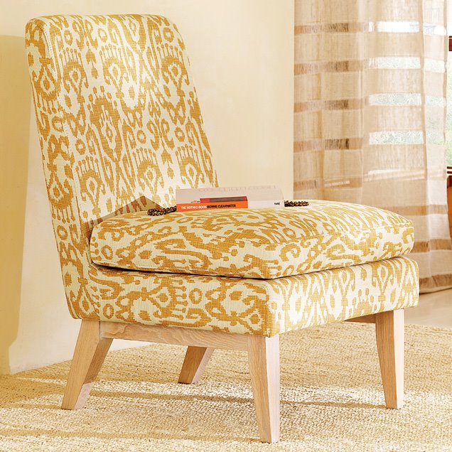 Slipper accent chair upholstered in woven Ikat upholstery in light yellow and ivory from West Elm