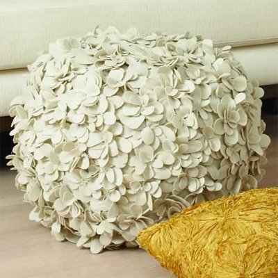 White round pouf ottoman or stool covered in hundreds of wool laser cut flowers from Modern Dose