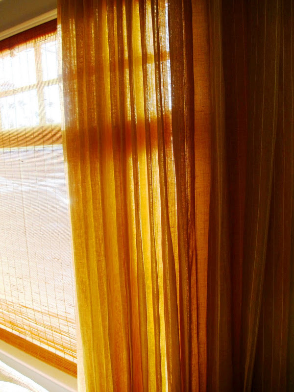 Bamboo window shades and natural fiber drapes in a living room in Venice Beach, CA