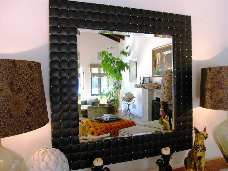 A modern quilted or tufted leather frame mirror in a living room in a Los Angeles home
