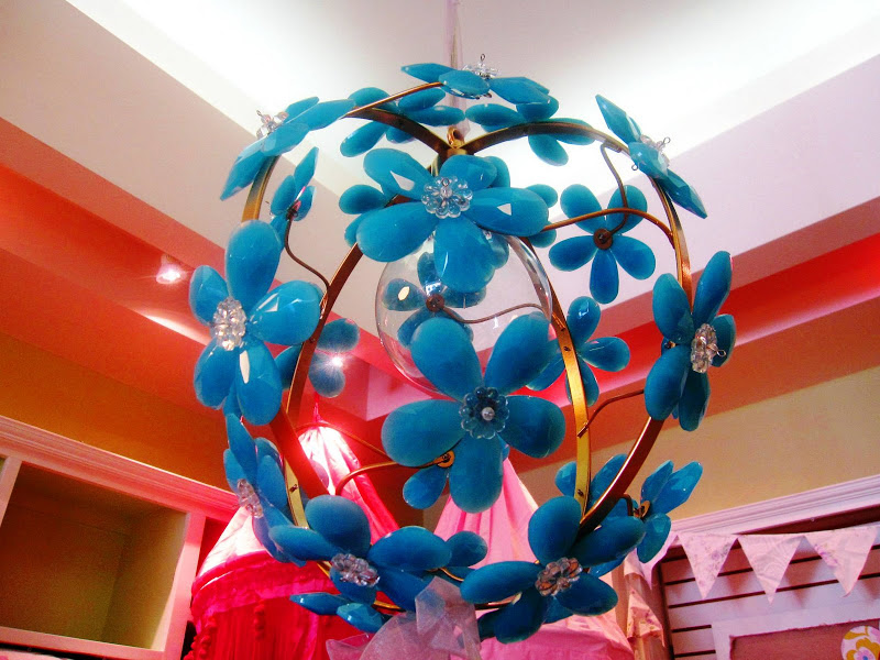 Round pendant light with turquoise blue crystals in the forms of flowers