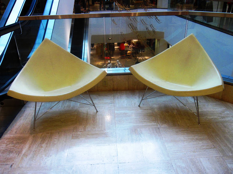 Two white leather futuristic chairs in Neiman Marcus