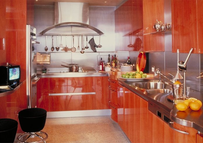 High glossy kitchen with lacquered exotic wood cabinets and drawers, stainless steel backsplash and glossy floor