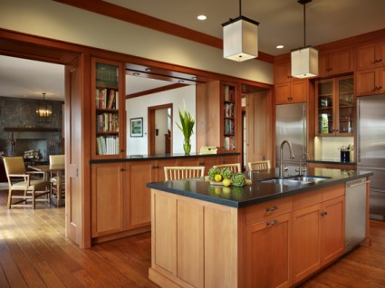 Wood paneled kitchen with wood cabinets with square recessed panel doors