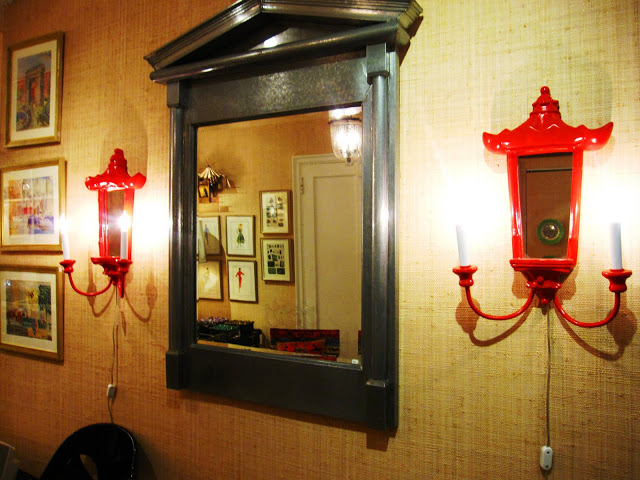 Red Chinoisserie inspired pagoda shaped wall sconces inside the Elizabeth Bauer store