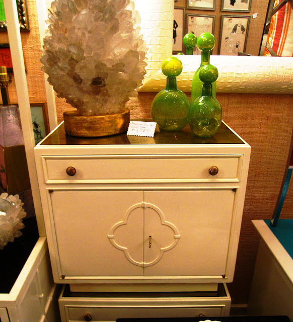 White lacquer side table with a lucite and gold told inside the Elizabeth Bauer store