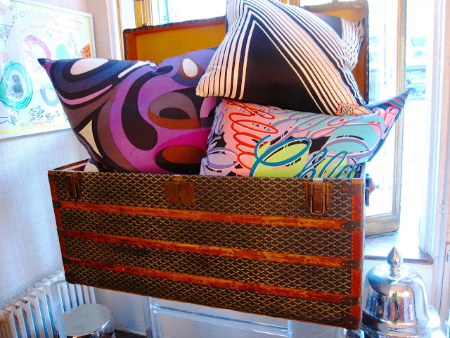 Vintage Goyard trunk filled with designer pillows inside the Elizabeth Bauer store