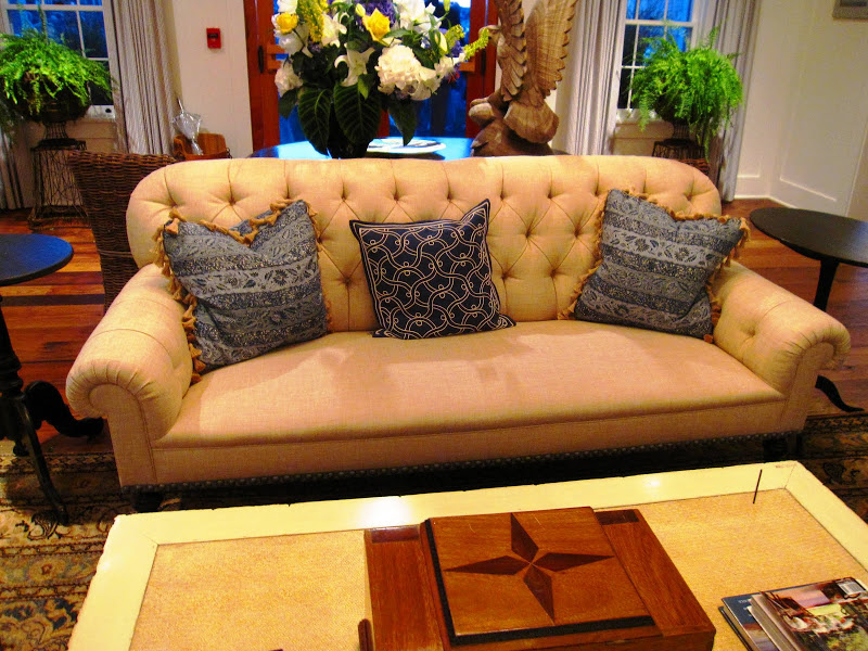 Tufted linen sofa with rolled arms in the sitting area at the Great Harbor Yacht Club