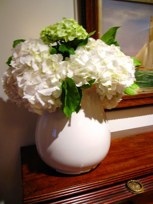White hydrangea in a white ceramic vase on a desk at the Great Harbor Yacht Club