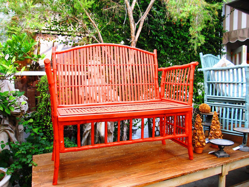 Red bamboo bench in the courtyard at Pom Pom Interiors