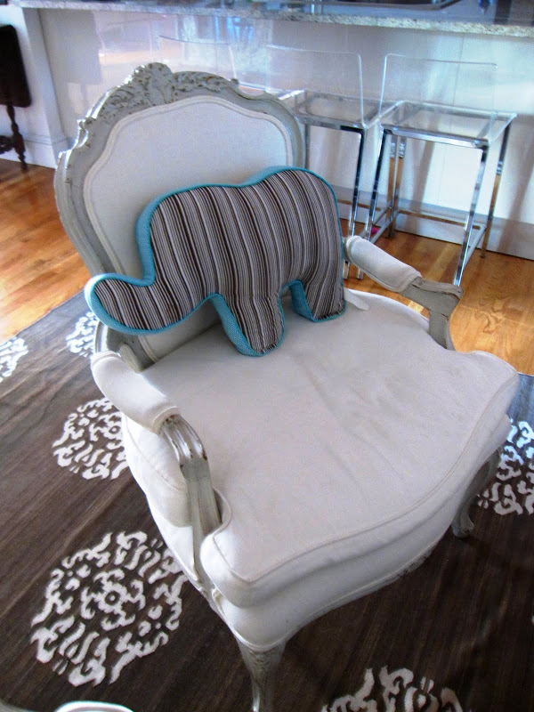 Louis XV style bergere with a Dwell Studio elephant pillow on a Madeline Weinrib wool rug