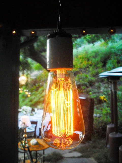 Close up of a custom designed outdoor light fixture that glow like vintage light bulbs