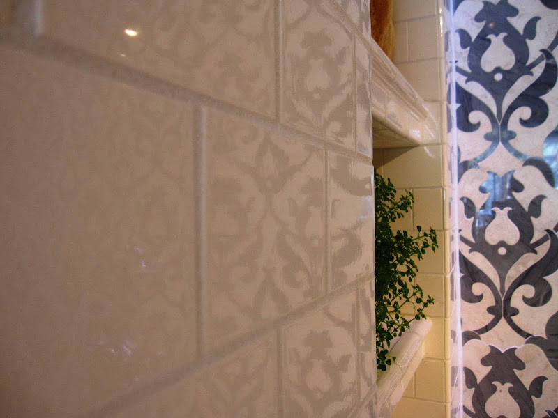 Damask marble subway tile wall inside Waterworks with built in shelves for storage 