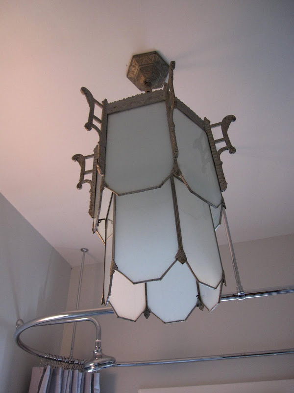 Art deco chandelier in a bathroom by Newman & Wolen Design