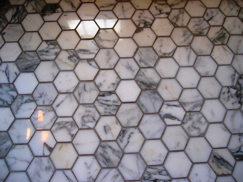 Hexagon Cararra marble mosaic floor in a bathroom by Newman & Wolen Design