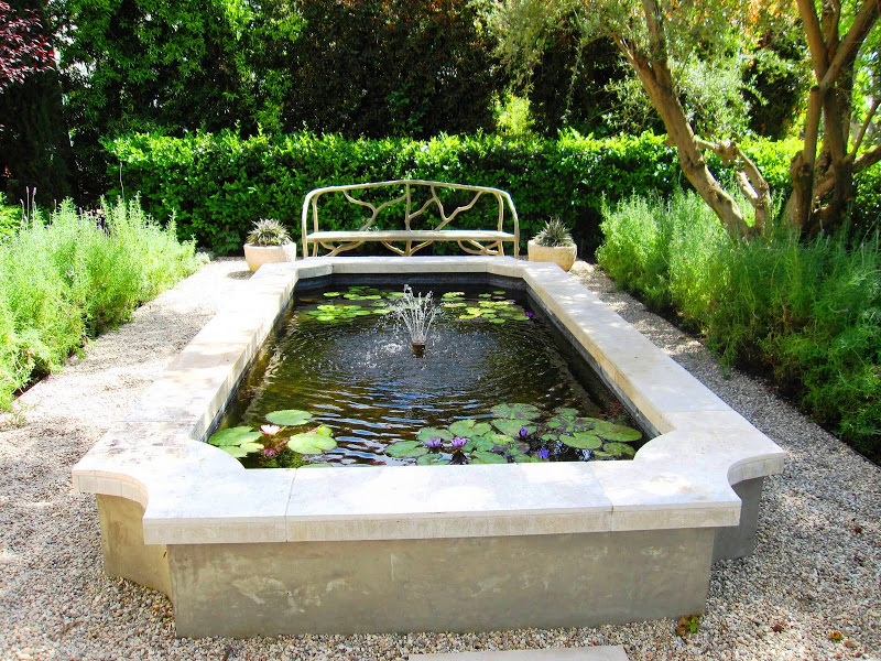 French inspired garden with a serene fountain with water lilies 