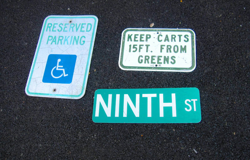Three street signs for sale at a flea market in New York City