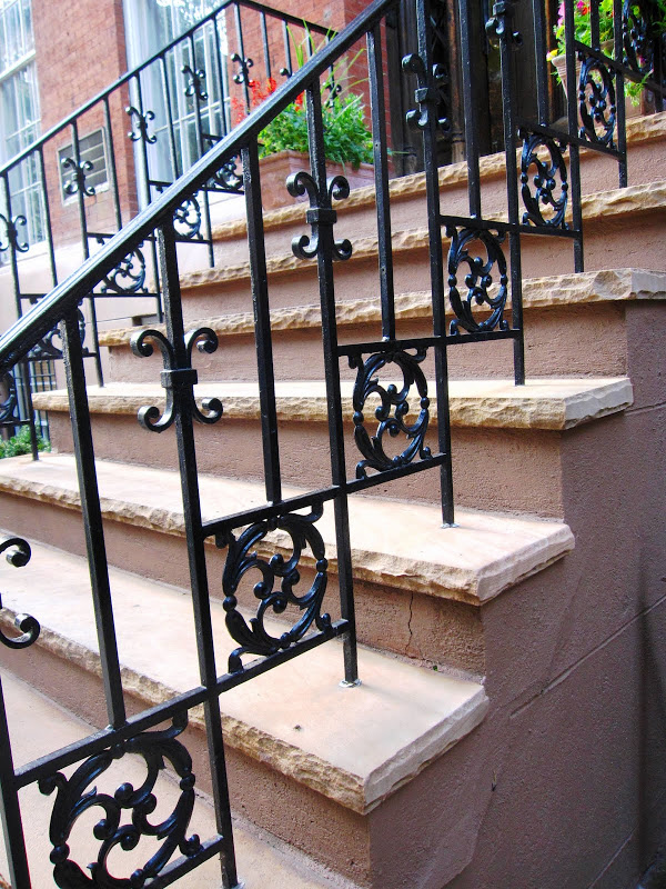 Beautiful iron railing on the stairs of a New York City Brownstone
