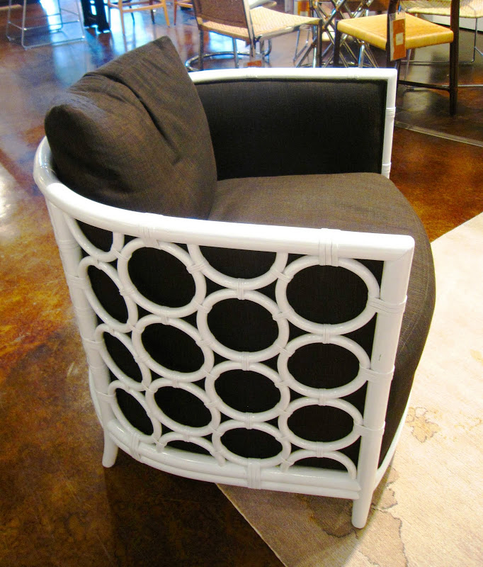 Side of a white rattan and wood armchair with circle ring detail by Laura Kirar from McGuire Furniture