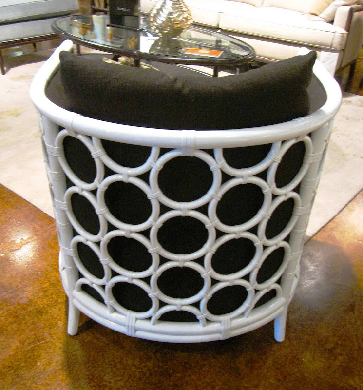 Back of a white rattan and wood armchair with circle ring detail by Laura Kirar from McGuire Furniture