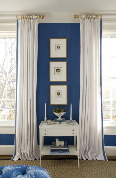 Bedroom by Kelley Proxmire with white curtains with blue trim and royal blue walls