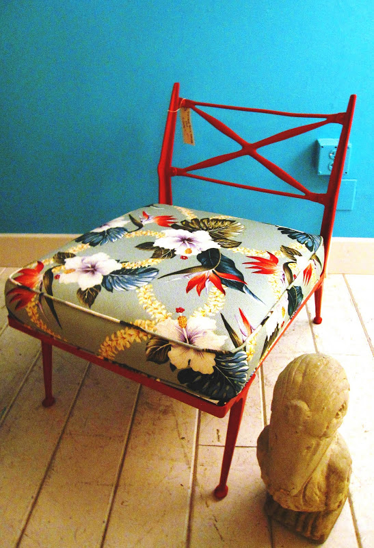 Vintage Billy Haines hot pink iron slipper chair with a floral cushion in Patio Culture in Venice Beach, CA