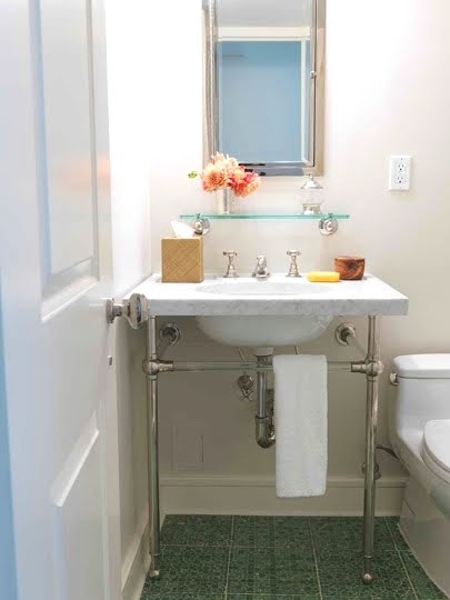 Small white powder room with chrome and marble washstand sink and green tile floor