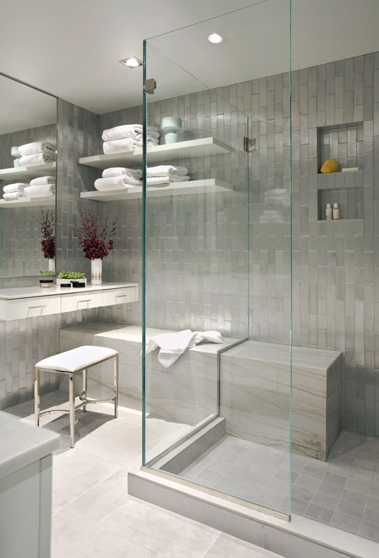Sleek sliver bathroom with glass shower, vertical subway tile walls and marble tile floor