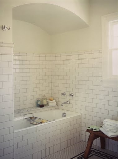 Bathroom nook by Kevin Oreck with a drop in tub and white subway tile