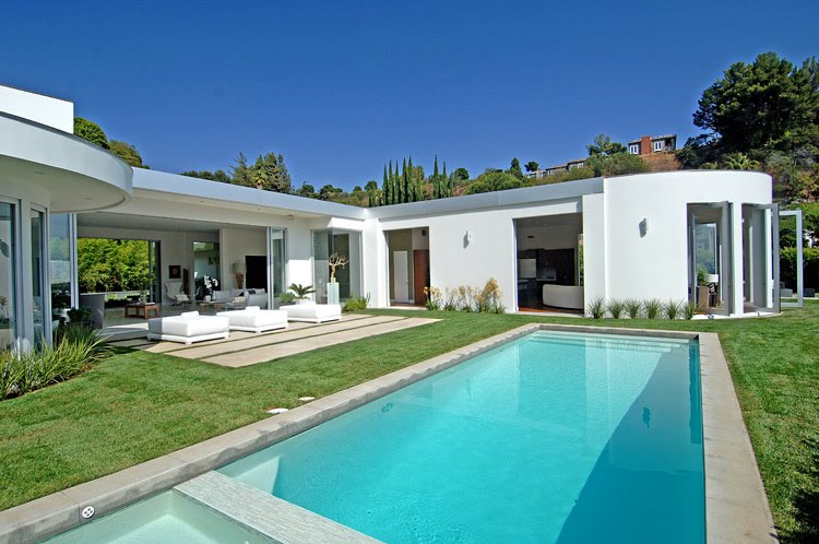 Modern Beverly Hills home by Meridith Baer & Associates with a large pool and lawn