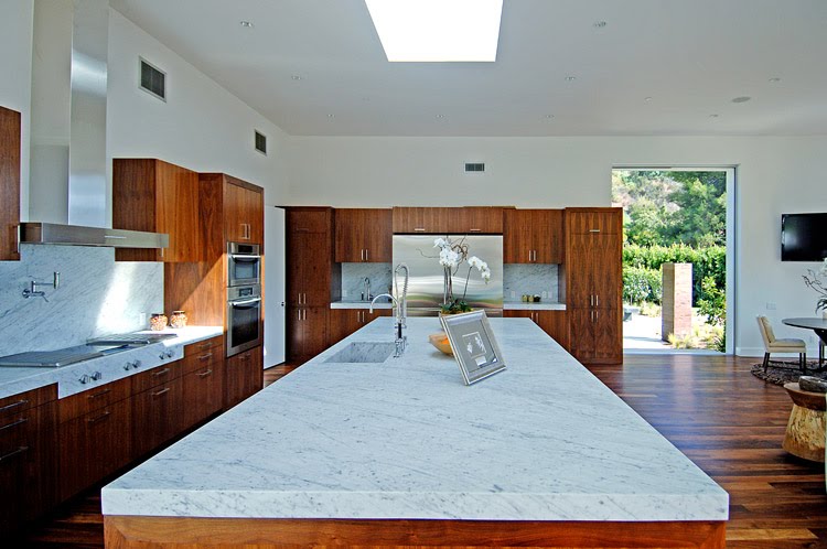 Huge kitchen island in a modern Beverly Hills home by Meridith Baer & Associates