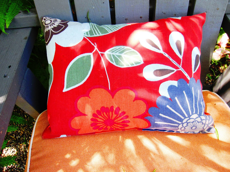 Close up of bright accent pillows on outdoor chairs in a backyard in Venice Beach, CA