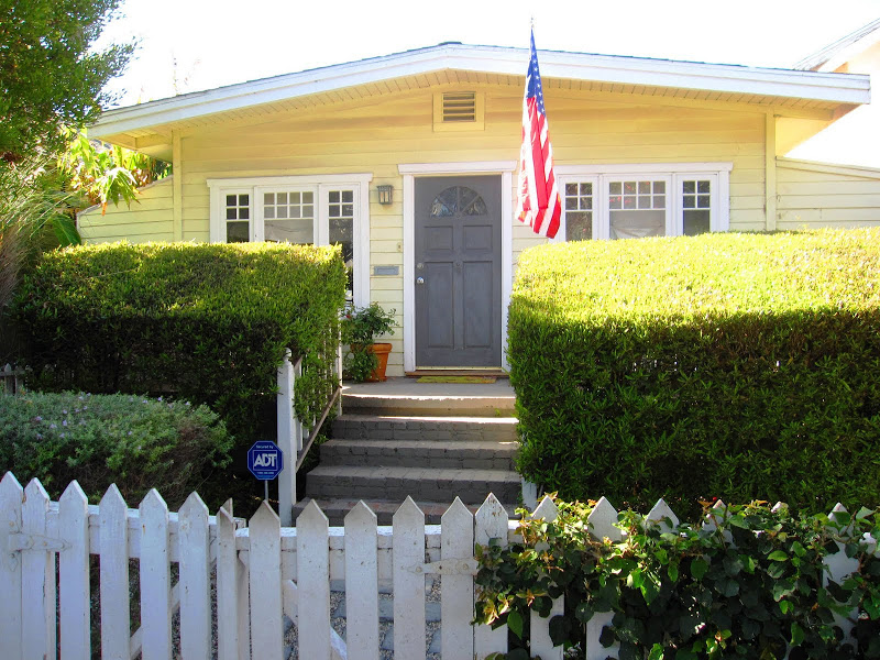 Yellow cottage with white trim and a grey door in Venice Beach, CA
